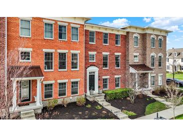 Exterior shot of colorful townhomes with brick facade and front yard landscaping at 2627 Congress St, Carmel, IN 46032