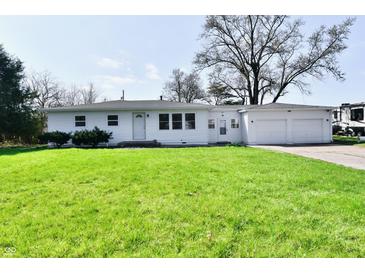 Charming single-story home with a well-manicured lawn and an attached two car garage at 3015 E Sumner Ave, Indianapolis, IN 46237
