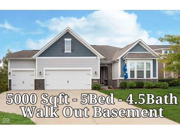 Charming two-story home with three-car garage, gray siding and stone accents on a well-manicured lawn at 4196 Parliament Way, Avon, IN 46123