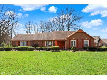 Charming brick home features a well-manicured lawn, tidy landscaping, and traditional shutters at 4263 W Fox Ridge Ave, Greenwood, IN 46143