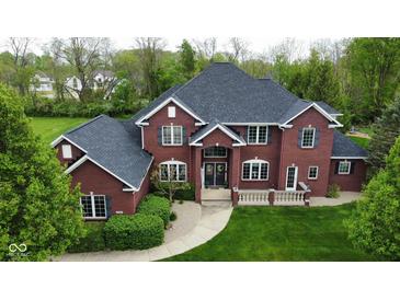 Beautiful red brick home with lush landscaping and a well-manicured lawn in a desirable neighborhood at 633 Foxboro Dr, Avon, IN 46123