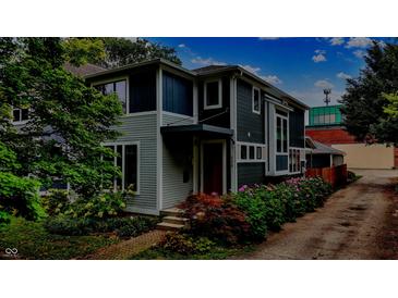 Charming two-story home with a lush landscaped yard and a welcoming front entrance at 634 Dorman St, Indianapolis, IN 46202