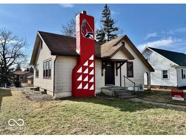 Charming one story home featuring a bold chimney design and freshly cut lawn at 921 W Carson St, Muncie, IN 47303