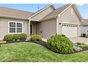 Charming home features a well-maintained lawn and tidy landscaping, enhancing its curb appeal at 11182 Black Gold Dr, Noblesville, IN 46060