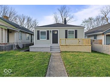 Charming single-story home featuring a neat front yard, gray siding, a small porch, and black shutters at 1331 W 33Rd St, Indianapolis, IN 46208