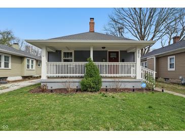 Charming home featuring a cozy front porch, well-maintained lawn, and inviting curb appeal at 4815 Winthrop Ave, Indianapolis, IN 46205