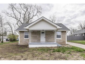 Charming stone home with a front porch and gray accents, offering a welcoming facade at 4945 Camden St, Indianapolis, IN 46227