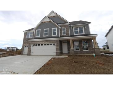 Newly built two-story home showcasing a three-car garage and stone and siding exterior at 4952 Cinnabar Trl, Brownsburg, IN 46112
