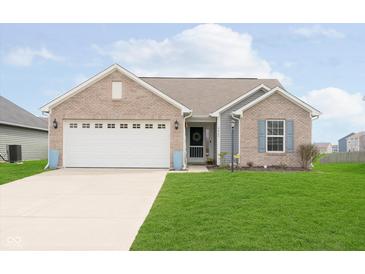 Well-maintained single-Gathering home with a two-car attached garage and manicured lawn at 6467 W Whispering N Way, Greenfield, IN 46140