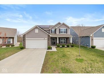 Charming two-story home featuring a well-maintained lawn and a two-car garage at 6535 Heben Ct, Indianapolis, IN 46113