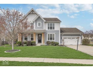 Charming two-story home featuring a well-manicured lawn, covered porch, and attached two car garage at 1458 Longleaf St, Avon, IN 46123
