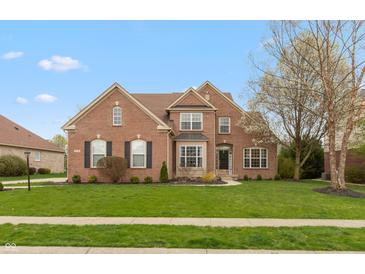 Charming brick home with well-manicured lawn and landscaping, with a 'Welcome' sign on the front entrance at 1559 Redsunset Dr, Brownsburg, IN 46112