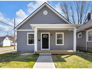 Charming home featuring a covered front porch, gray siding, and a well-manicured lawn, creating a welcoming curb appeal at 2041 N Dexter St, Indianapolis, IN 46202