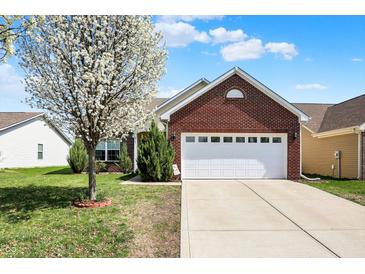 Charming brick home featuring an attached two-car garage and a well-maintained front lawn at 2307 Cedarmill Dr, Franklin, IN 46131