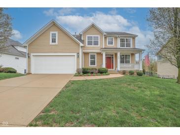 Charming two-story home with a well-manicured lawn and a cozy front porch with red door at 2889 Grimes Way, Columbus, IN 47201