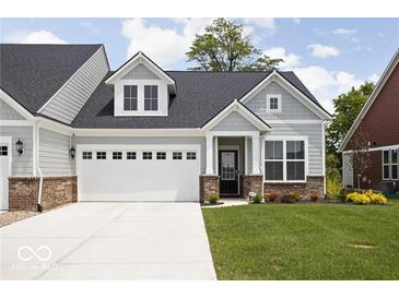 Charming home with a two-car garage and well-manicured lawn at 745 Stone Trace Ct, Avon, IN 46123