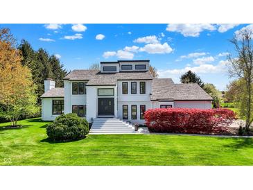 Stunning two-story home with manicured lawn, vibrant landscaping, and a grand entryway at 7531 Normandy Blvd, Indianapolis, IN 46278