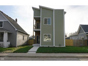 Modern two-story home featuring a charming front yard and beautiful exterior paint at 1038 St Peter St, Indianapolis, IN 46203