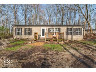 Inviting single-story home with a charming front porch and well-maintained landscaping at 10614 W Hickory Ct, Quincy, IN 47456