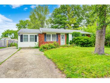 Charming single story home with red brick and white siding, green lawn and partial driveway at 11416 Stoeppelwerth Dr, Indianapolis, IN 46229
