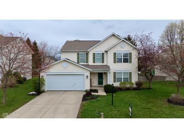 Charming two-story home with a well-maintained lawn and attached two-car garage at 13993 Whittier Dr, Fishers, IN 46038