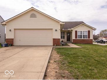 Charming single-Gathering home with a two-car garage, vinyl siding, and a well-maintained front lawn at 2179 W Van Arsdall Ct, Columbus, IN 47201