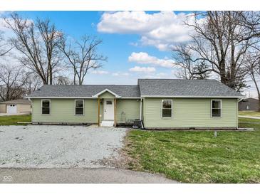 Charming one-story home with light green siding, gray roof, and a gravel front yard at 2264 Walnut W St, Greenfield, IN 46140