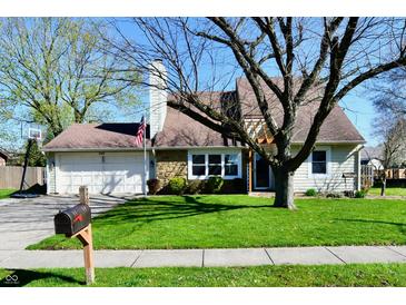 Charming single-Gathering home features a well-manicured lawn, attached garage, and classic American flag at 260 Christina Dr, Whiteland, IN 46184