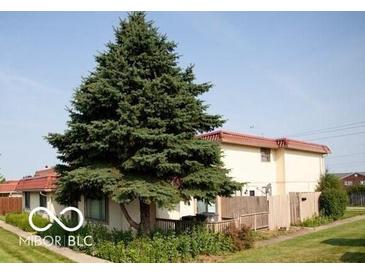 Exterior view of home with a large tree in the yard and mature landscaping at 2804 Paso Del Norte Dr, Indianapolis, IN 46227