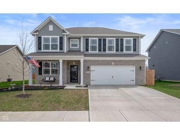 Charming two-story home with a two-car garage, covered front porch, and a swing at 315 Limerick Ln, Pendleton, IN 46064