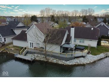 Waterfront home with deck, gazebo, and hot tub overlooking calm water, providing serene outdoor living at 3260 Eddy Ct, Indianapolis, IN 46214