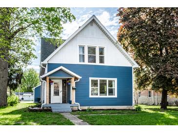 Charming two-story home with a blue exterior, well-maintained lawn, and inviting front porch at 421 S East St, Plainfield, IN 46168