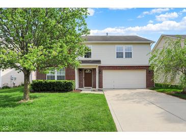 Two-story home featuring a front yard, brick accents, a driveway, and an attached two-car garage at 5861 W Deerview Bnd, McCordsville, IN 46055