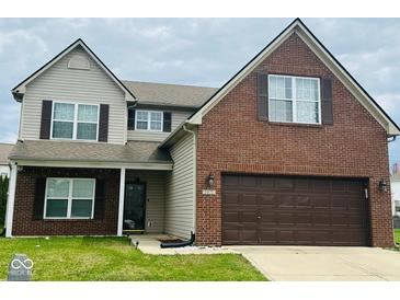 Charming two-story home with brick and vinyl siding, attached garage, and well-maintained lawn at 1071 Hazelwood Dr, Greenwood, IN 46143