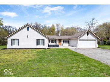 Charming single-story home with a white painted brick facade, attached garage, and well-maintained lawn at 1520 E 87Th St, Indianapolis, IN 46240