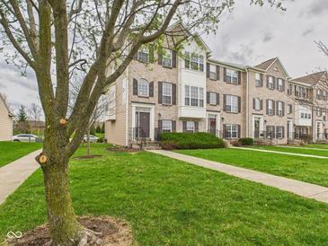 Brick townhomes feature sidewalks and professionally maintained landscaping at 170 Straughn Ln, Westfield, IN 46074