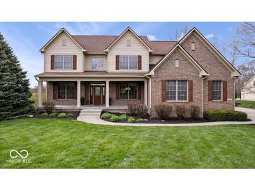Charming two-story home with manicured lawn, covered porch, brick accents, and classic curb appeal at 20251 Dayspring Ct, Noblesville, IN 46062