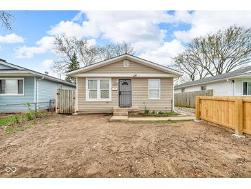 Charming single-story home with light siding, updated windows, and a secure front entrance at 2055 N Somerset Ave, Indianapolis, IN 46222