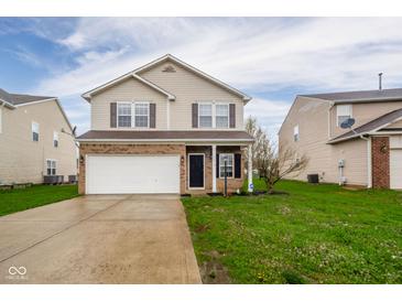 Charming two-story home with a two-car garage and well-maintained lawn and inviting curb appeal at 2416 Meadow Bend Dr, Columbus, IN 47201