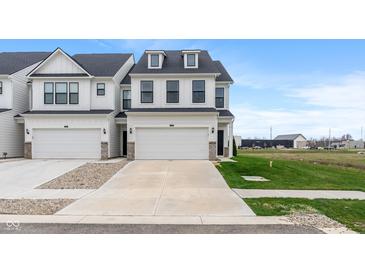 New construction home with white siding, black trim, driveway, and two car garage at 3240 Arabian Ln, Zionsville, IN 46077