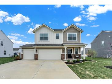 Charming two-story home featuring a spacious three-car garage and manicured lawn at 371 Bluestem Ln, Whiteland, IN 46184