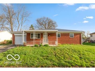 Charming single-story brick home with covered front porch and well-maintained lawn at 5838 W Henry St, Indianapolis, IN 46241
