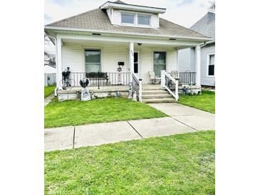 Charming home with a covered front porch, decorative railings, and well-maintained lawn at 640 W South St, Shelbyville, IN 46176