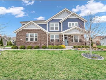 Charming two-story home with a brick facade, blue siding, manicured lawn, and inviting curb appeal at 682 Keswick Dr, Brownsburg, IN 46112