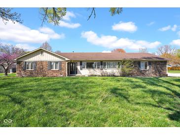 Charming single-story brick home with a well-maintained lawn and mature trees under a bright blue sky at 758 Stafford Rd, Plainfield, IN 46168