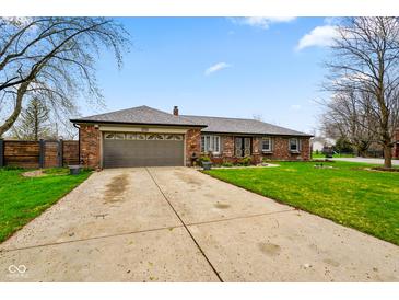 Charming brick home featuring a two-car garage, well-kept lawn, and welcoming curb appeal at 7714 Kenneth Ct, Brownsburg, IN 46112