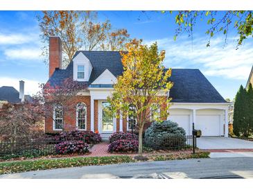 Charming brick home with dormers, two-car garage, and colorful landscaping at 8040 Lynch Ln, Indianapolis, IN 46250