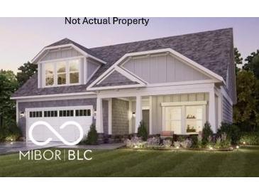 Charming home featuring a two-car garage, manicured lawn and craftsman-style architectural details at 9150 Bryce Cir, Zionsville, IN 46077