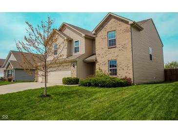 Charming two-story home featuring a blend of brick and siding, complemented by a green lawn at 10016 Jenna Ln, Indianapolis, IN 46239