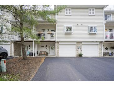 Inviting townhome featuring a private balcony, individual garage, and charming curb appeal at 1127 Island Woods Dr # 56, Indianapolis, IN 46220